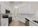 Modern kitchen with white cabinets, stainless steel appliances, and a functional design at 6501 Appaloosa Dr, Tampa, FL 33625