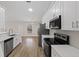 Beautiful kitchen featuring new appliances, white cabinetry, and wood-look flooring at 6501 Appaloosa Dr, Tampa, FL 33625
