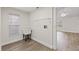 Bright laundry room with utility sink, open shelf storage, and wood-look flooring at 6501 Appaloosa Dr, Tampa, FL 33625