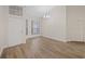 Open living room featuring wood-look flooring, modern lighting, and a bright, airy feel at 6501 Appaloosa Dr, Tampa, FL 33625