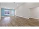 Bright living room area featuring wood-look flooring, a large window, and modern lighting at 6501 Appaloosa Dr, Tampa, FL 33625