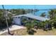 Aerial view of waterfront home showcasing mature trees and landscaping at 712 Sunset Cv, Madeira Beach, FL 33708