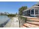 Waterfront home with a backyard beach, dock, and a beautiful view of the water at 712 Sunset Cv, Madeira Beach, FL 33708