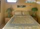 Comfortable bedroom with a patterned quilt, matching bedside lamps, and a relaxing atmosphere at 712 Sunset Cv, Madeira Beach, FL 33708