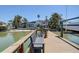 Waterfront home featuring a private dock and boat lift, ideal for boating enthusiasts at 712 Sunset Cv, Madeira Beach, FL 33708