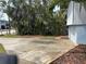 Exterior with expansive concrete driveway and side view of home framed by lush landscaping at 712 Sunset Cv, Madeira Beach, FL 33708