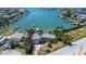 Waterfront home featuring lush tropical landscaping, a private dock, and stunning views of the harbor at 712 Sunset Cv, Madeira Beach, FL 33708