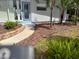 Charming home with a well-maintained front yard, landscaping, and a paved walkway at 712 Sunset Cv, Madeira Beach, FL 33708