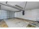 Spacious garage featuring concrete flooring and an overhead door at 712 Sunset Cv, Madeira Beach, FL 33708