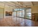 Open-concept living room with large windows overlooking the waterfront and tile flooring at 712 Sunset Cv, Madeira Beach, FL 33708