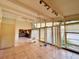 Spacious living room featuring tile floors, exposed beams, and large windows at 712 Sunset Cv, Madeira Beach, FL 33708