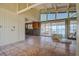 Spacious living room with water views, large windows, tile floors, and modern ceiling fan at 712 Sunset Cv, Madeira Beach, FL 33708