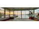 Spacious sunroom boasting floor-to-ceiling windows with serene water views and natural light throughout at 712 Sunset Cv, Madeira Beach, FL 33708