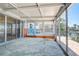 Enclosed sunroom with concrete tile, large glass doors and windows provides views of the waterfront at 712 Sunset Cv, Madeira Beach, FL 33708