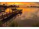 Scenic view of a dock and calm water at sunset, offering a serene and picturesque setting at 712 Sunset Cv, Madeira Beach, FL 33708