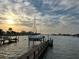 Waterfront community at sunset, showcasing a boat at dock and the tranquil atmosphere of the area at 712 Sunset Cv, Madeira Beach, FL 33708