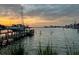 Scenic view of a dock on a waterfront property with a beautiful sunset at 712 Sunset Cv, Madeira Beach, FL 33708