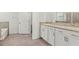 Bathroom boasts double sinks with granite counters, tile floor, and separate tub and shower at 7139 Steer Blade Dr, Zephyrhills, FL 33541
