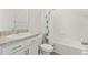 Bathroom with white tile, vanity, mirror, and tub with shower at 7139 Steer Blade Dr, Zephyrhills, FL 33541