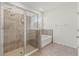 Bright bathroom with tile shower, soaking tub, and tiled floors for spa-like feel at 7139 Steer Blade Dr, Zephyrhills, FL 33541