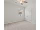 Bright bedroom featuring neutral carpet, ceiling fan, and window for natural light at 7139 Steer Blade Dr, Zephyrhills, FL 33541