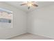 Bedroom features neutral carpet, ceiling fan, and a window at 7139 Steer Blade Dr, Zephyrhills, FL 33541