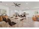 Open dining area with a marble-look table, modern chairs, and white kitchen in the background at 7139 Steer Blade Dr, Zephyrhills, FL 33541