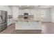 Modern kitchen features white cabinetry, granite countertops and stainless steel appliances at 7139 Steer Blade Dr, Zephyrhills, FL 33541