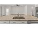 Close up view of the kitchen island with stainless steel sink and granite countertop at 7139 Steer Blade Dr, Zephyrhills, FL 33541