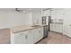 A kitchen island with granite counters and stainless steel appliances overlooks the living space at 7139 Steer Blade Dr, Zephyrhills, FL 33541
