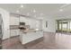 Kitchen featuring white cabinets, granite countertops, stainless steel appliances and tile flooring at 7139 Steer Blade Dr, Zephyrhills, FL 33541