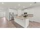 Bright kitchen features stainless steel appliances, granite counters, a center island and tile floors at 7139 Steer Blade Dr, Zephyrhills, FL 33541