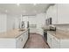 The kitchen features stainless steel appliances, granite counters, white cabinets and tile floors at 7139 Steer Blade Dr, Zephyrhills, FL 33541