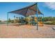 Community playground features a colorful slide and play structure with a shade for safety and fun at 7139 Steer Blade Dr, Zephyrhills, FL 33541