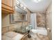 Well-lit bathroom featuring a glass vessel sink, decorative mirror, and tiled shower-tub combination at 785 5Th S St, Safety Harbor, FL 34695
