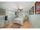 Cozy bedroom with light green walls, hardwood floors, a ceiling fan, and plenty of natural light at 785 5Th S St, Safety Harbor, FL 34695