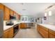 Well-lit kitchen showcases stainless steel appliances, granite countertops, custom cabinetry, and easy access to the dining area at 785 5Th S St, Safety Harbor, FL 34695