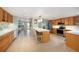 Spacious kitchen featuring wood cabinets, tiled floors, stainless steel appliances, and a large center island at 785 5Th S St, Safety Harbor, FL 34695