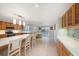 Open kitchen boasts stainless appliances, an island with seating, and seamless flow to the dining area and the outdoor pool at 785 5Th S St, Safety Harbor, FL 34695
