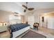 Spacious bedroom features a ceiling fan, neutral color palette, large window, and flows into the ensuite bathroom at 785 5Th S St, Safety Harbor, FL 34695