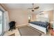 Inviting bedroom boasts a ceiling fan, exterior access, a neutral color palette, and an en-suite bathroom at 785 5Th S St, Safety Harbor, FL 34695