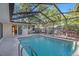 Inviting in-ground pool inside screened enclosure, with lounge area access at 785 5Th S St, Safety Harbor, FL 34695