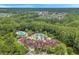 Aerial view featuring the community clubhouse, swimming pools, and surrounding residential area at 8226 Summer Brook Ct, Land O Lakes, FL 34638