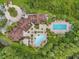 Aerial view of the community clubhouse, pools, and lush green surroundings at 8226 Summer Brook Ct, Land O Lakes, FL 34638