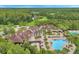 Expansive aerial view of the community clubhouse, pool, and lush green surroundings, showing the serene setting at 8226 Summer Brook Ct, Land O Lakes, FL 34638