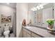Bathroom vanity features a white sink, gray granite countertop, and gray accents at 8226 Summer Brook Ct, Land O Lakes, FL 34638
