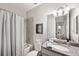 Well-lit bathroom features a shower-tub combo and granite countertop vanity at 8226 Summer Brook Ct, Land O Lakes, FL 34638