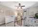 Bright Bedroom with two cribs, neutral tones, and ceiling fan at 8226 Summer Brook Ct, Land O Lakes, FL 34638