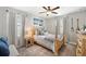 Inviting bedroom with natural light, a four-poster bed, and stylish decor at 8226 Summer Brook Ct, Land O Lakes, FL 34638