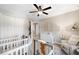 Adorable Bedroom with two cribs, a changing table, and a comfortable chair at 8226 Summer Brook Ct, Land O Lakes, FL 34638